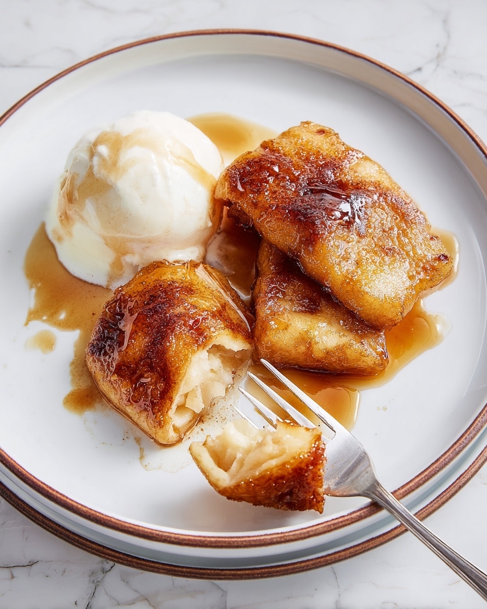 A white plate with a thin brown rim holds three pieces of golden brown fried apple fritters with a shiny cinnamon sauce drizzled over them. To the left of the fritters is a scoop of white vanilla ice cream with a light brown sauce on top, melting slightly at the edges. A silver fork pierces a piece of fritter in the lower center of the plate. The background is a white marbled texture. photo taken with an iphone --ar 4:5 --v 7