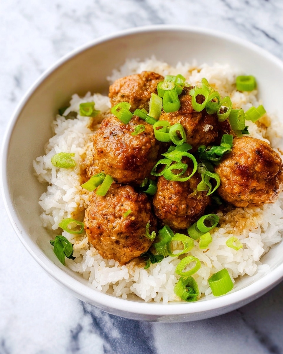 A white speckled round plate holds a bed of fluffy white rice arranged in a circular shape, topped in the center with several pieces of golden brown meatballs that are rough-textured and irregular in shape, garnished with small chopped green onions scattered on top and around the plate. To the upper left, a white bowl is filled with finely chopped bright green onions, while a small white dish with yellow scrambled eggs is partially visible at the far left. The entire setting is on a white marbled surface with a blue and white striped cloth to the right side. Photo taken with an iphone --ar 4:5 --v 7