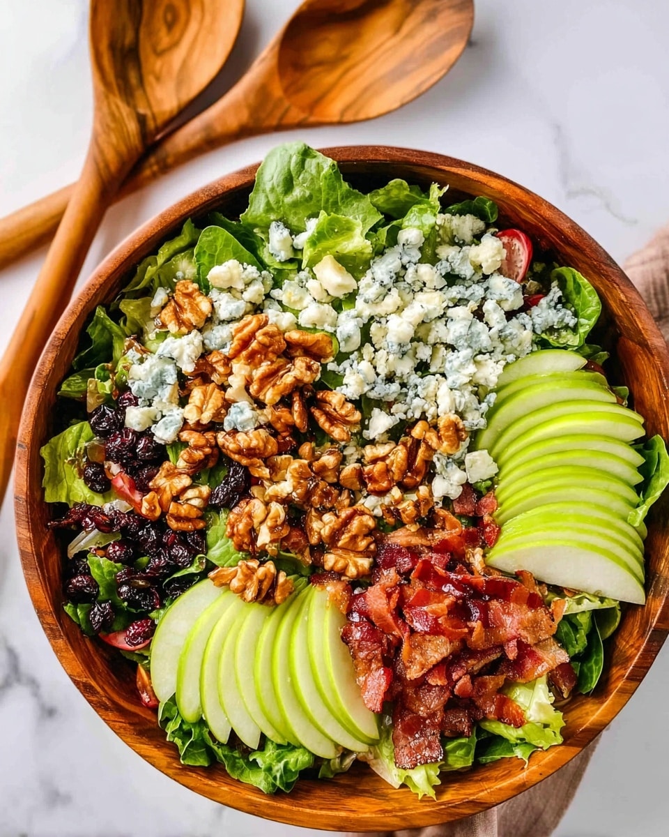 A wooden bowl is filled with a colorful salad displayed in many layers starting with a base of green leafy lettuce. On top of the leaves, there are thinly sliced green apple slices arranged in small neat stacks around the bowl. Scattered over the salad are crumbled blue cheese pieces, black dried berries, and crunchy brown walnuts covered lightly with a glossy dressing. Crispy reddish-brown bacon strips and small bacon pieces are placed around the edges and among the layers. The bowl sits on a white marbled surface next to two wooden spoons. photo taken with an iphone --ar 4:5 --v 7
