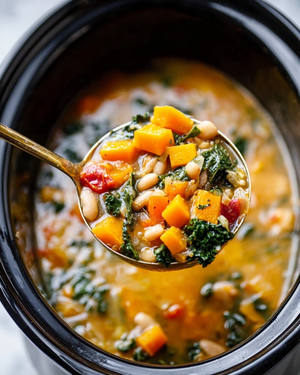 A close-up image of a ladle full of vegetable soup held over a black slow cooker filled with the same soup on a white marbled surface. The ladle contains bright orange chunks of squash, small beige white beans, dark green leafy kale, small pieces of red bell pepper, and short white pasta in a clear broth with bits of herbs and vegetables. The slow cooker rim is thick, smooth, and shiny black with the soup slightly steaming inside. photo taken with an iphone --ar 4:5 --v 7