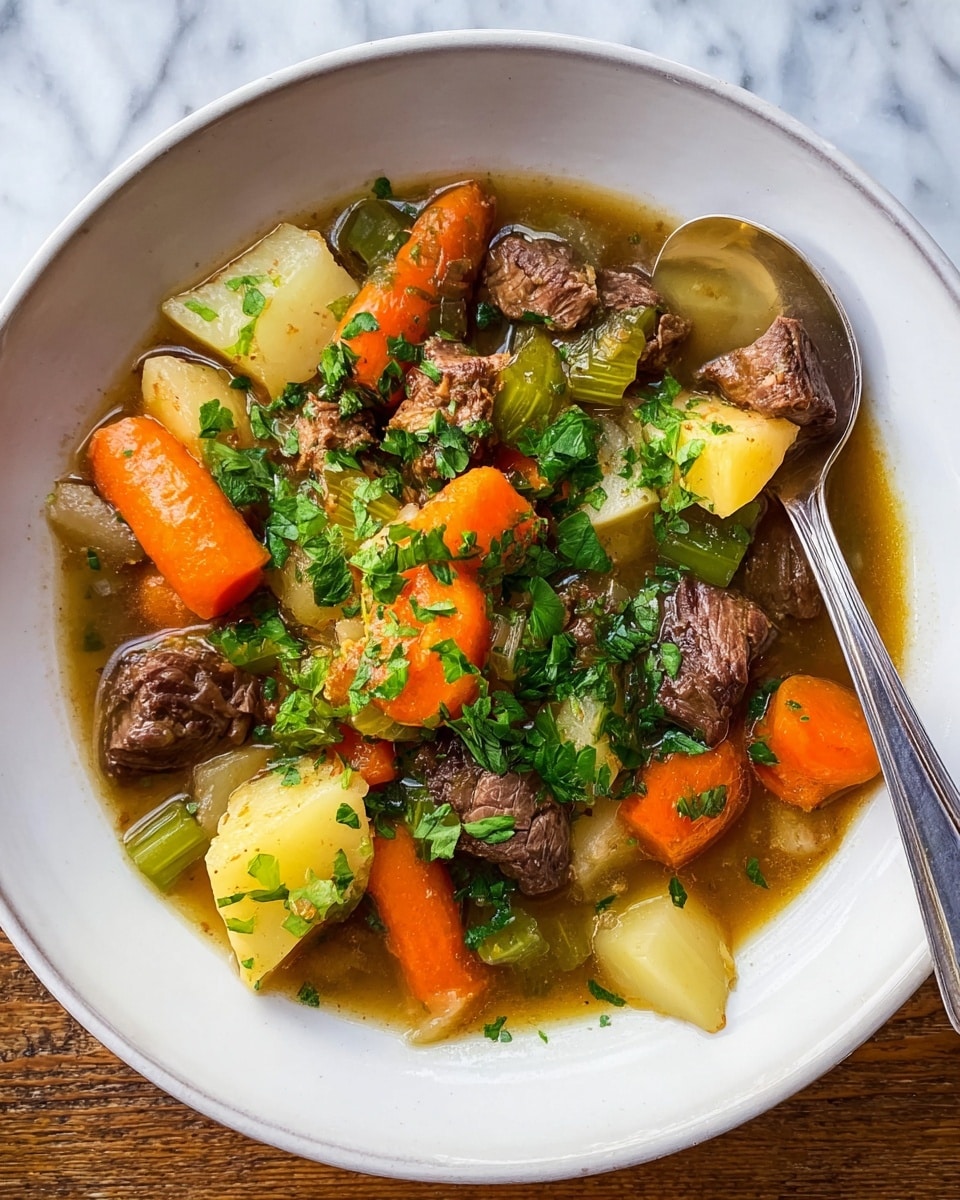 A white bowl is filled with a warm beef stew showing three main layers: at the bottom, a clear brown broth surrounds the ingredients; in the middle, large chunks of bright orange carrots and light yellow potatoes are scattered; and on top, tender brown pieces of beef and green celery chunks are mixed together. The whole dish is sprinkled with chopped green parsley. A silver spoon rests on the edge of the bowl, and the bowl sits on a wood surface. photo taken with an iphone --ar 4:5 --v 7