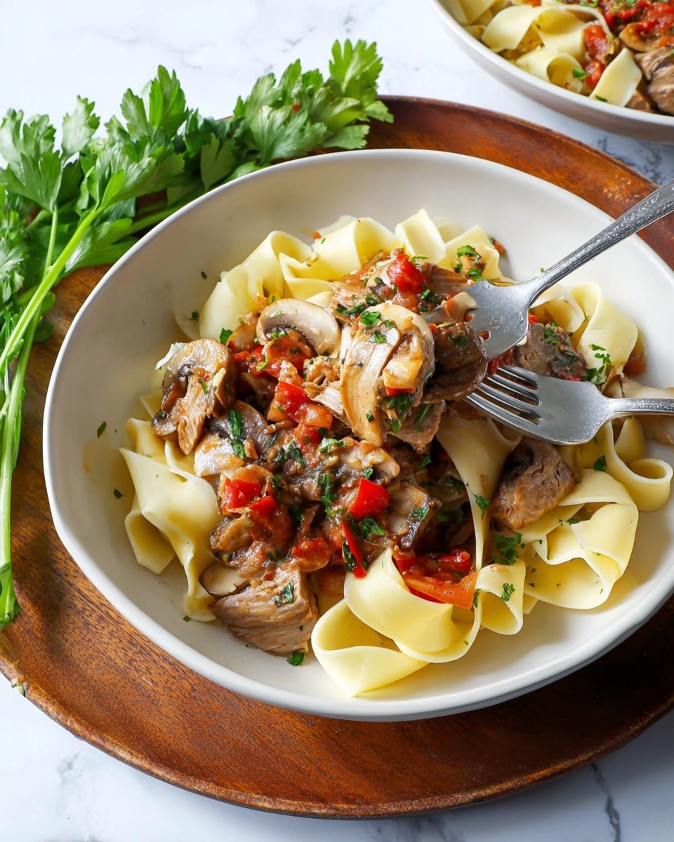 Two white bowls filled with a dish of three layers each sit on a white marbled surface. The bottom layer in each bowl is a bed of pale yellow wide pasta noodles, arranged in loose swirls. On top of the pasta is a thick, chunky mixed vegetable sauce with pieces of red tomatoes, brown mushrooms, and orange carrots, showing a rich texture. The top layer features a piece of cooked chicken thigh with light golden skin in the center, garnished with bright green chopped parsley scattered over the dish. The bowl at the bottom right is placed on a round wooden serving board with a handle, beside a small bunch of fresh leafy parsley. Photo taken with an iphone --ar 4:5 --v 7