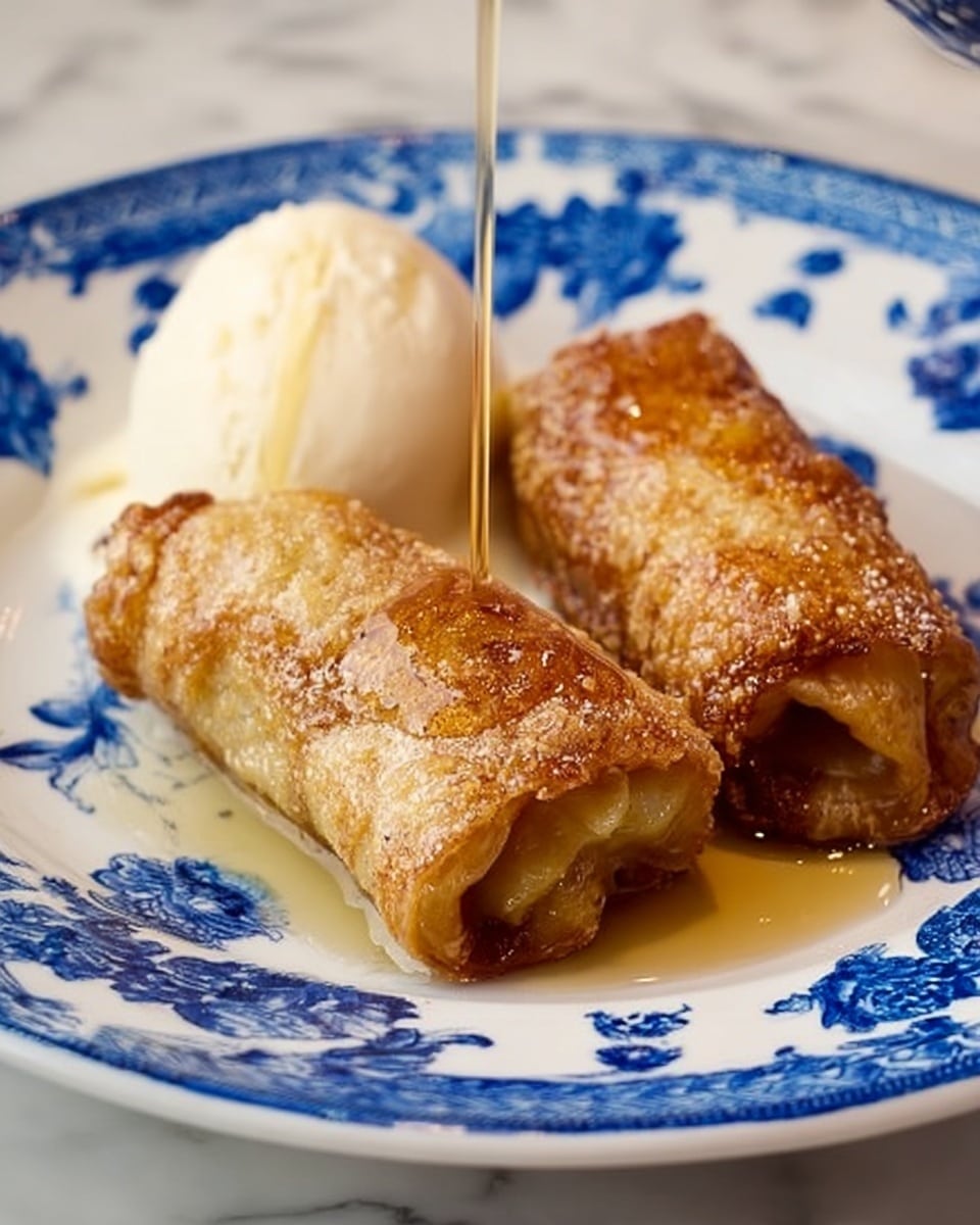 Two rolled, golden brown crepes with a slightly crispy texture sit side by side on a white plate decorated with blue floral patterns. They are covered with a drizzle of syrup that is being poured from above by a woman's hand. To the right of the crepes, there is a scoop of smooth white vanilla ice cream. The plate rests on a white marbled surface in soft, natural light. Photo taken with an iphone --ar 4:5 --v 7