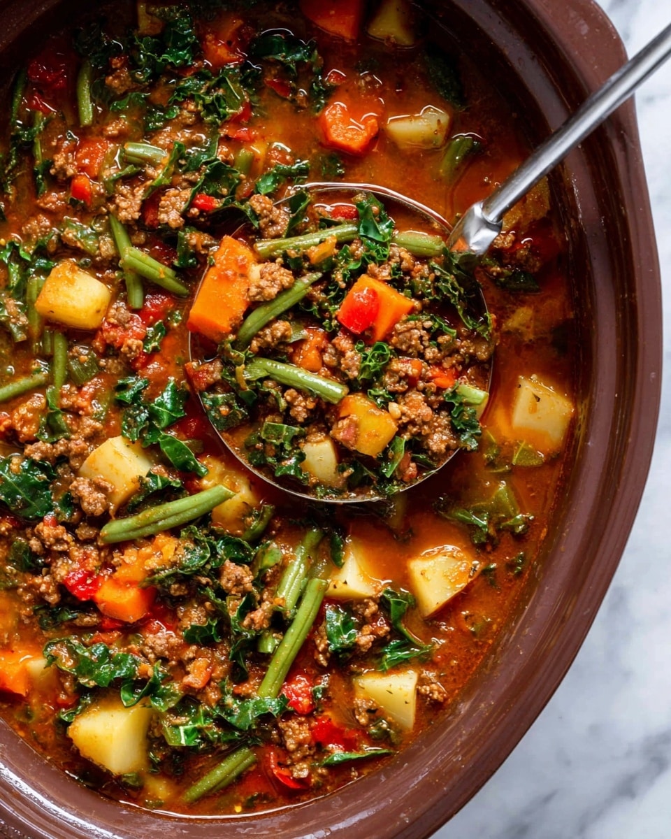 A close-up view of a thick vegetable and meat stew in a brown pot, showing a rich reddish-brown broth filled with chopped green beans, orange carrots, yellow potatoes, green kale leaves, and ground meat bits. A silver ladle is scooping some stew, highlighting the colorful mix of vegetables and meat pieces, all soaked in the hearty sauce. The background is a white marbled texture. photo taken with an iphone --ar 4:5 --v 7