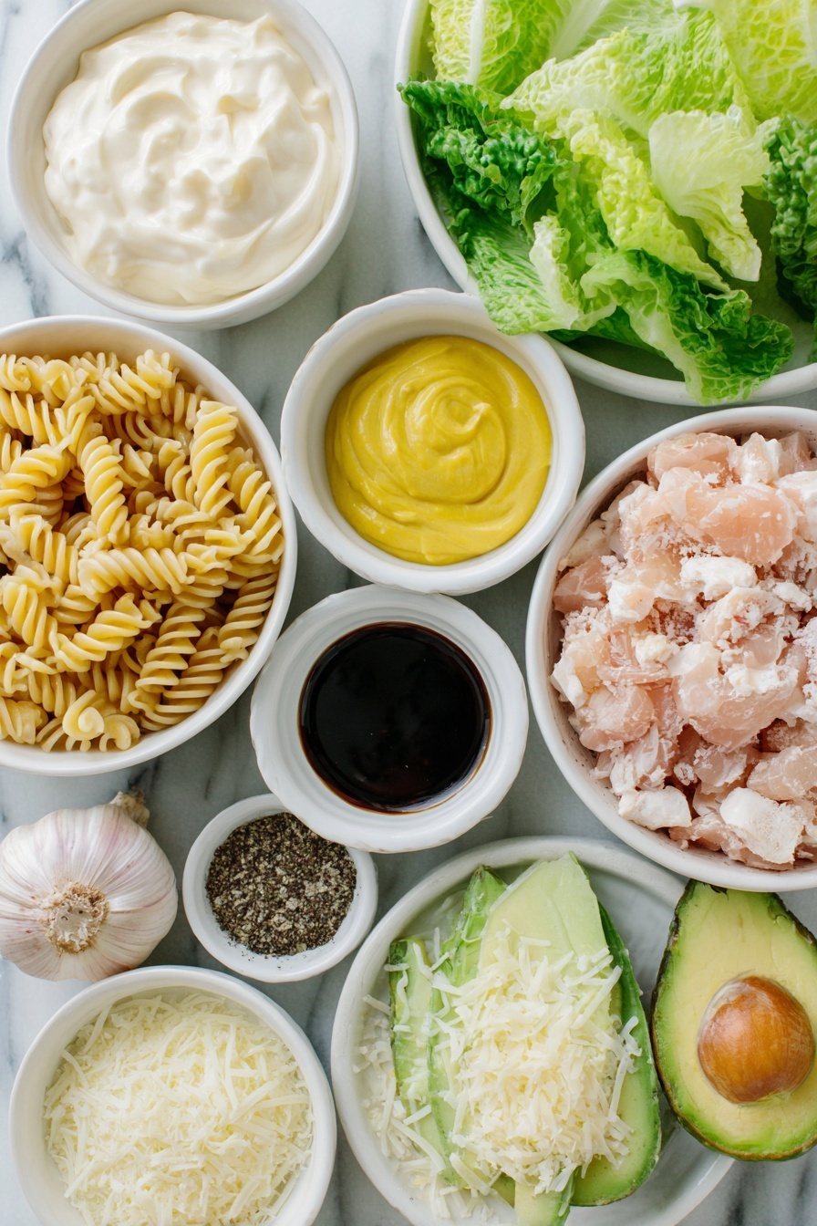 Flat lay of a small white ceramic bowl of creamy mayonnaise, a small white bowl of finely grated Parmesan cheese, a small white bowl with fresh bright yellow lemon zest and lemon juice, three whole uncracked brown garlic cloves, a small white bowl of smooth Dijon mustard, a small white bowl of ground black pepper, a small white bowl of dark Worcestershire sauce, a small white ceramic bowl filled with cooked fusilli corti bucati pasta, a simple white ceramic plate with chopped crisp romaine lettuce, a simple white ceramic plate with cooked chopped chicken breast pieces, a simple white ceramic plate with halved vibrant red cherry tomatoes, a simple white ceramic plate holding a peeled, pitted, and diced avocado, and a small white bowl with thin shavings of Parmesan cheese, all arranged in perfect symmetry with realistic proportions, placed on a clean white marble surface, soft natural light, photo taken with an iPhone, professional food photography style, fresh ingredients, white ceramic bowls, no bottles, no duplicates, no utensils, no packaging --ar 2:3 --v 7 --p m7354615311229779997 - Chicken Caesar Pasta Salad, Chicken Caesar Salad, Pasta Salad with Chicken, Easy Chicken Caesar Recipes, Summertime Pasta Salad