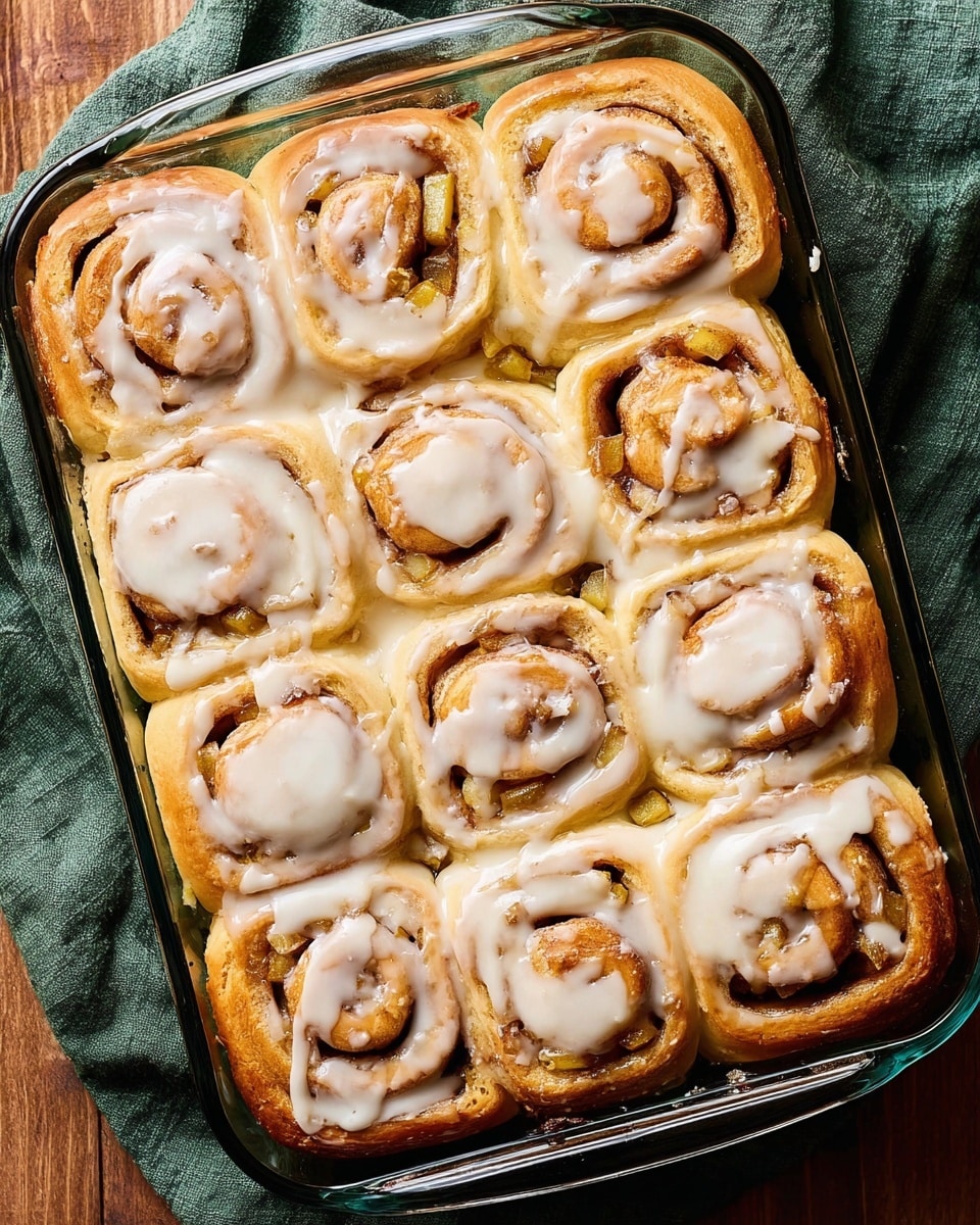 The image shows two green apples at the top left and two white eggs below them, all placed on a dark green cloth. Next to the eggs are two white packets of platinum baking yeast with red and blue text. On the bottom right, there is a white bowl with a red floral pattern inside, holding two thick blocks of pale yellow butter. The whole setup is on a white marbled surface. Photo taken with an iphone --ar 4:5 --v 7