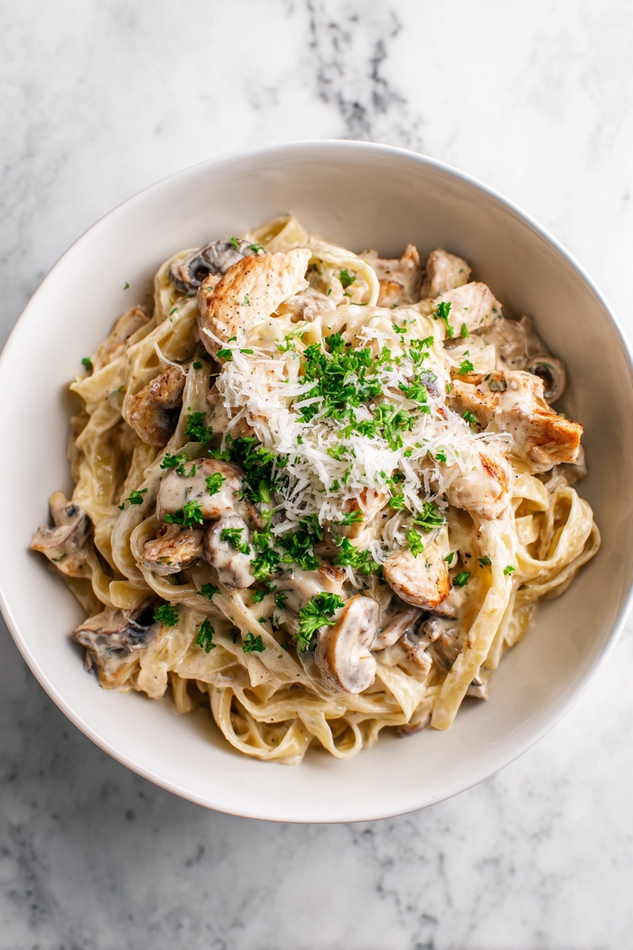 A bowl with three layers shows a creamy pasta dish. The bottom layer is flat, wide noodles tangled inside a thick light beige sauce. The middle layer is made of cooked mushroom slices and golden shrimp pieces that mix well with the noodles. On top, white grated cheese is scattered with small green parsley flakes lightly on the whole dish. The bowl is white and sits on a white marbled surface. photo taken with an iphone --ar 2:3 --v 7 - Creamy Chicken Marsala Pasta, Chicken Marsala pasta recipe, easy Chicken Marsala pasta, quick creamy chicken pasta, gourmet chicken pasta dishes