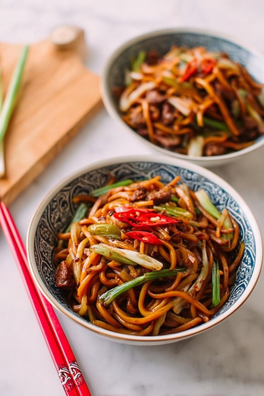 Two white bowls with blue patterned edges are filled with cooked noodles mixed with thin strips of orange carrots, light brown meat pieces, and pale yellow bean sprouts, all coated in a shiny brown sauce. The bowls sit on a soft beige cloth on a white marbled surface. Near the top bowl, two pairs of chopsticks lay on the table, one pair red with gold tips and the other partially visible in brown. The noodles look soft and slightly tangled, with some green vegetable slices visible among the layers. Photo taken with an iphone --ar 2:3 --v 7 - Easy Restaurant-Style Chicken Lo Mein, Chicken Lo Mein, Chinese Chicken Noodles, Homemade Lo Mein, Quick Chicken Stir Fry