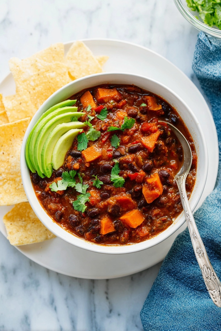 This image shows a large white pot filled with thick, rich brown bean stew with visible chunks of orange carrots and dark beans scattered throughout, giving it a hearty texture. Some green herb bits are sprinkled lightly on top, adding small spots of color. A wooden spoon is partially dipped into the stew on the right side, lifting some of the stew with a thick, chunky texture. The pot sits on a white marbled surface and parts of the pot's inner sides have reddish-brown sauce splashes. A blue cloth is partly visible at the lower right edge. photo taken with an iphone --ar 2:3 --v 7 - Vegetarian Chili, Vegetarian Chili Recipe, Meat-Free Chili, Healthy Vegetarian Chili, Cozy Vegetarian Chili
