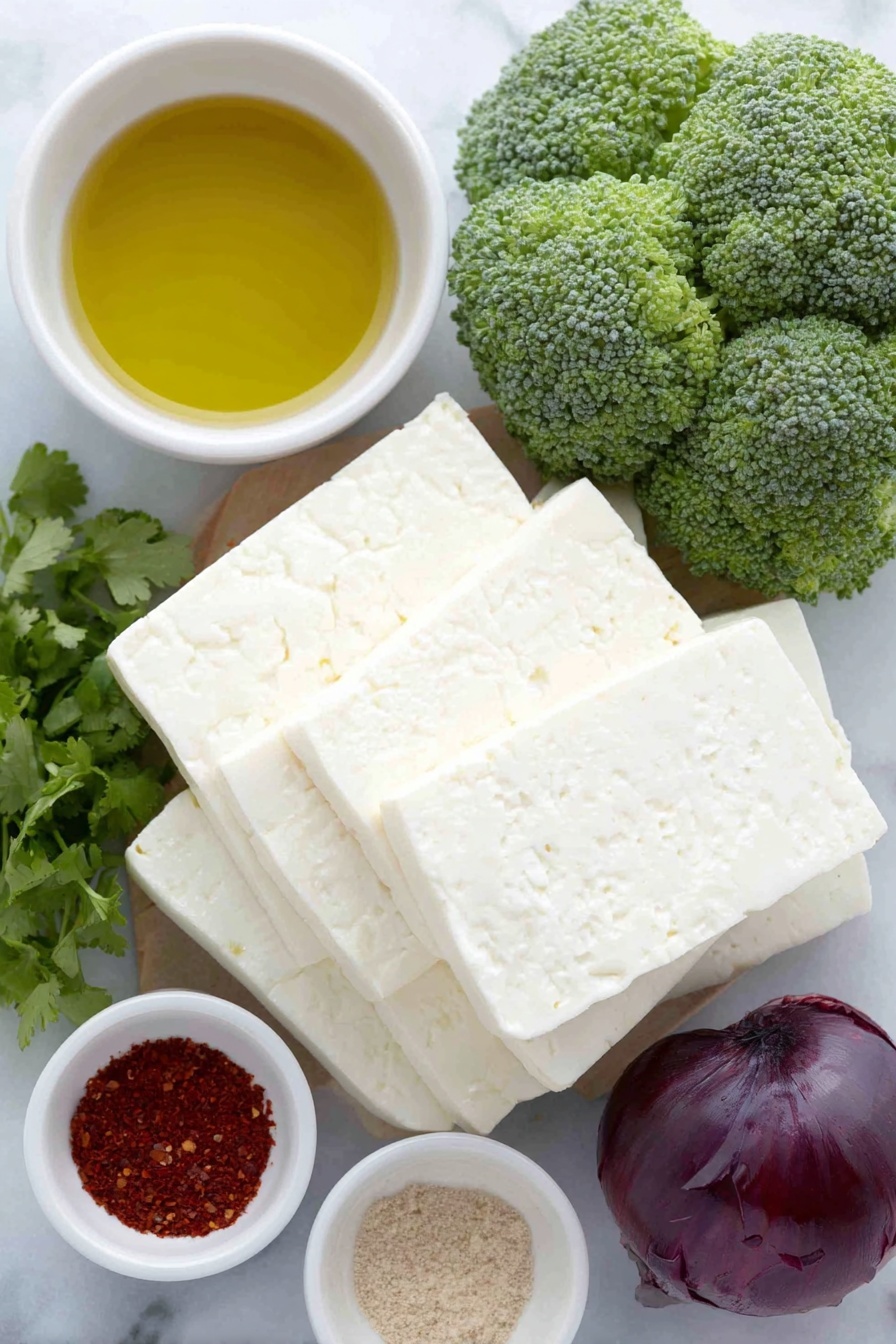 Flat lay of a stack of rectangular half-inch thick halloumi cheese slices, a large bright red bell pepper chopped into one-inch pieces, a small mound of fresh green broccoli florets, a small pile of chopped deep purple red onion, a few sprigs of fresh green cilantro leaves, a small white ceramic bowl filled with golden olive oil, a tiny white ceramic bowl holding bright red paprika powder, and a tiny white ceramic bowl with earthy brown cumin powder, placed on a clean white marble surface, soft natural light, photo taken with an iPhone, professional food photography style, fresh ingredients, white ceramic bowls, no bottles, no duplicates, no utensils, no packaging --ar 2:3 --v 7 --p m7354615311229779997 - Sheet Pan Halloumi with Roasted Vegetables, easy vegetarian dinner, healthy sheet pan recipes, baked halloumi recipes, quick vegetable side dishes