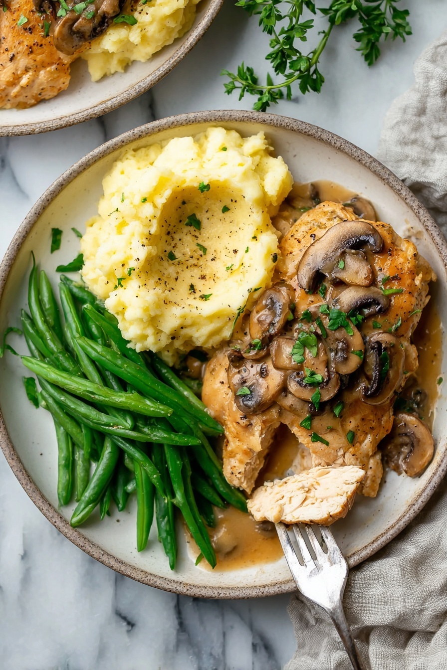 The dish shows a white plate with three main sections: mashed potatoes on the top left, creamy and light yellow with some pepper specks and a layer of brown mushroom gravy partially covering it; green beans on the bottom left, bright green and fresh, plain with no sauce; and a piece of cooked chicken on the right, golden-brown and topped with mushroom slices and fresh chopped green herbs. The chicken has one slice held by a fork resting on the right edge of the plate, showing the inside texture. The background is a white marbled surface with a piece of cloth on the right side. photo taken with an iphone --ar 2:3 --v 7 - Chicken Marsala with Mushrooms, Chicken Marsala, Mushroom Chicken Marsala, Easy Chicken Marsala, Italian Chicken Recipes