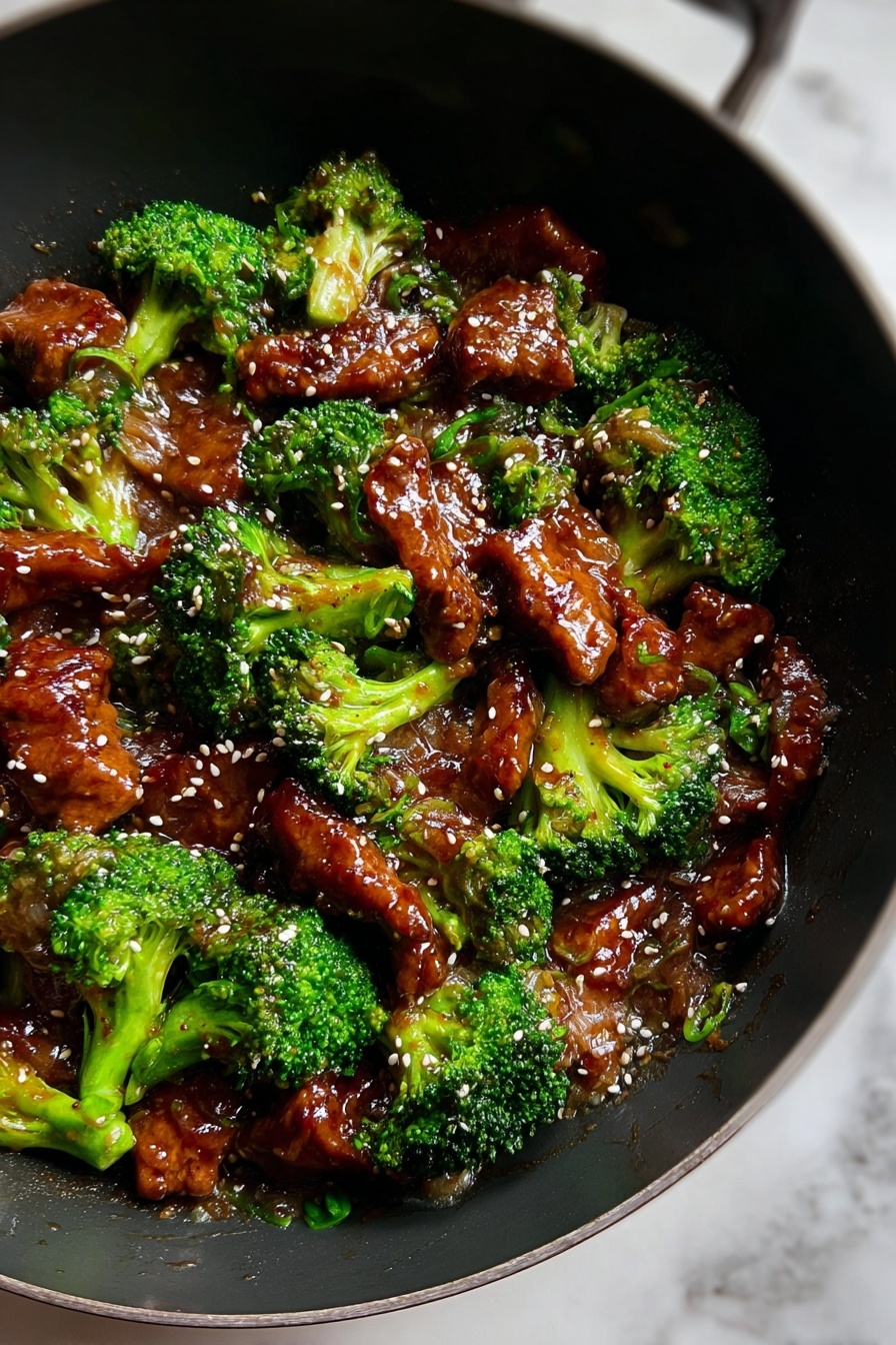 The dish shows about two layers mixed together in a black wok on a white marbled surface. The first layer is bright green broccoli florets that look fresh and slightly glossy. The second layer consists of shiny, brown pieces of meat coated in a thick sauce. Light-colored sesame seeds are sprinkled evenly on top, adding small spots of contrast. The sauce gives the meat a wet and glossy texture, while the broccoli adds a rough, natural look. The whole dish looks warm and tasty, with a good mix of colors and textures. Photo taken with an iphone --ar 2:3 --v 7 - Chinese Beef with Garlic Sauce, Chinese beef stir-fry, garlic beef recipe, Chinese takeout at home, easy Chinese beef dish
