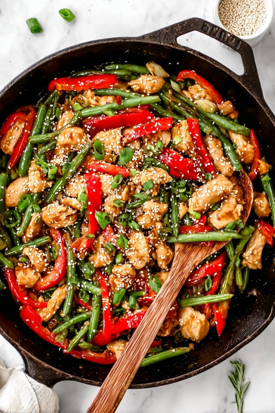 A black cast iron pan filled with a colorful stir-fry showing three main layers: the base layer has shiny, green beans with a fresh texture spread all around; the middle layer has bright red sliced bell pepper strips adding a pop of color mixed evenly; the top layer contains chunks of light brown cooked chicken pieces sprinkled with white sesame seeds and chopped green onions, giving it a fresh and textured look. On the right side, a wooden spoon with a natural grain rests inside the pan, partly covered by the food. The whole scene is set on a white marbled surface with a small white bowl of sesame seeds and a green herb sprig partially visible. Photo taken with an iphone --ar 2:3 --v 7 - Healthy Orange Chicken Stir Fry with Cauliflower Rice, healthy orange chicken stir fry, low-carb orange chicken, cauliflower rice recipes, quick healthy dinner
